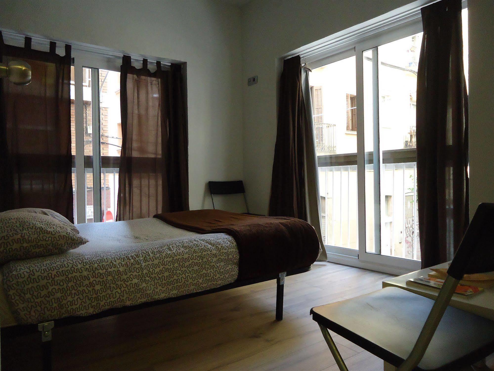 Gracia City Hostel Barcelona Bagian luar foto A bedroom in a typical apartment
